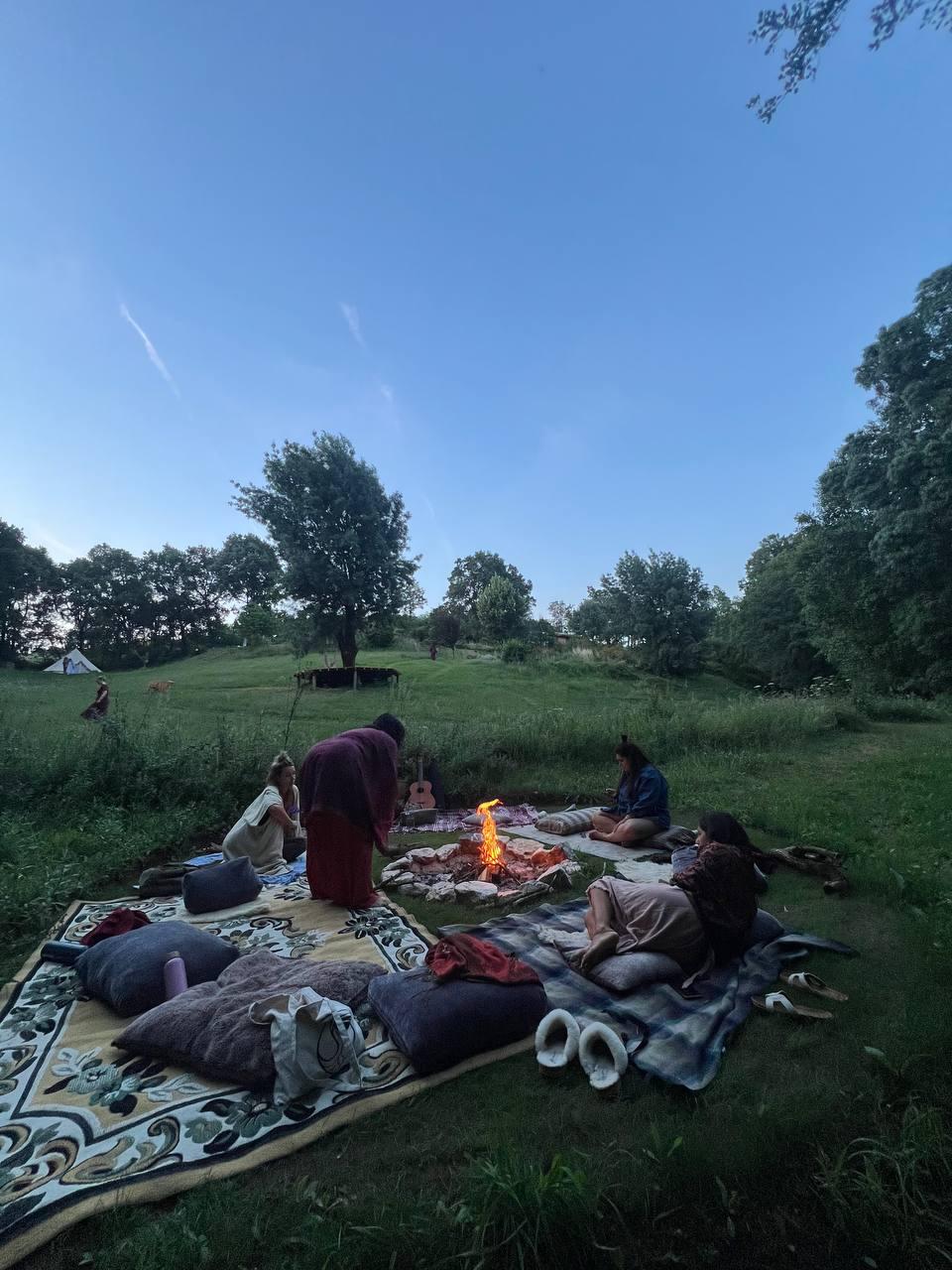 A small circle around the evening fire at dusk